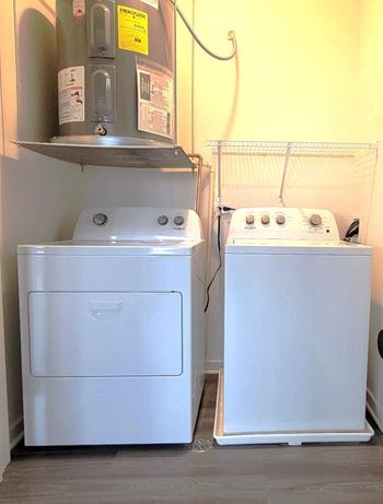 two washers and a dryer in a small room at Enclave Crystal Lake Townhomes and Apartments, Crystal Lake, 60014